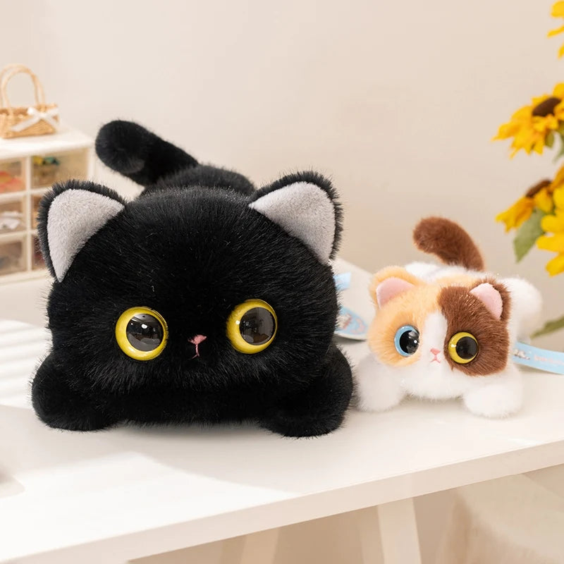 Gatito de peluche negro de ojos amarillos