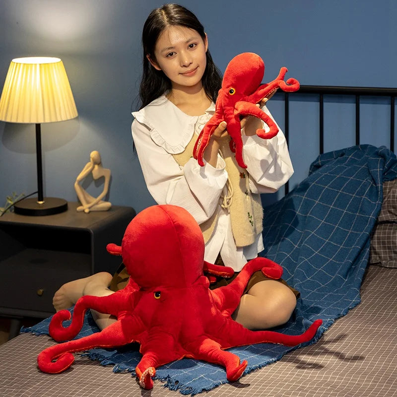 Chica con un pulpo de peluche grande